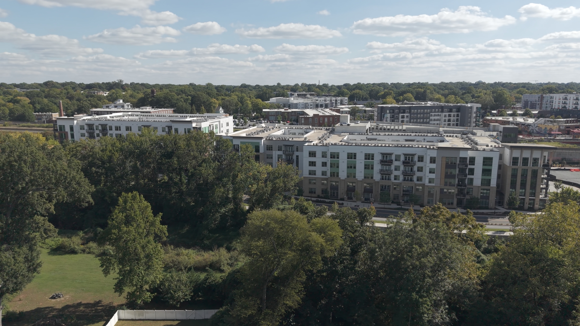Complex framed by the tree canopy · October 6, 2026