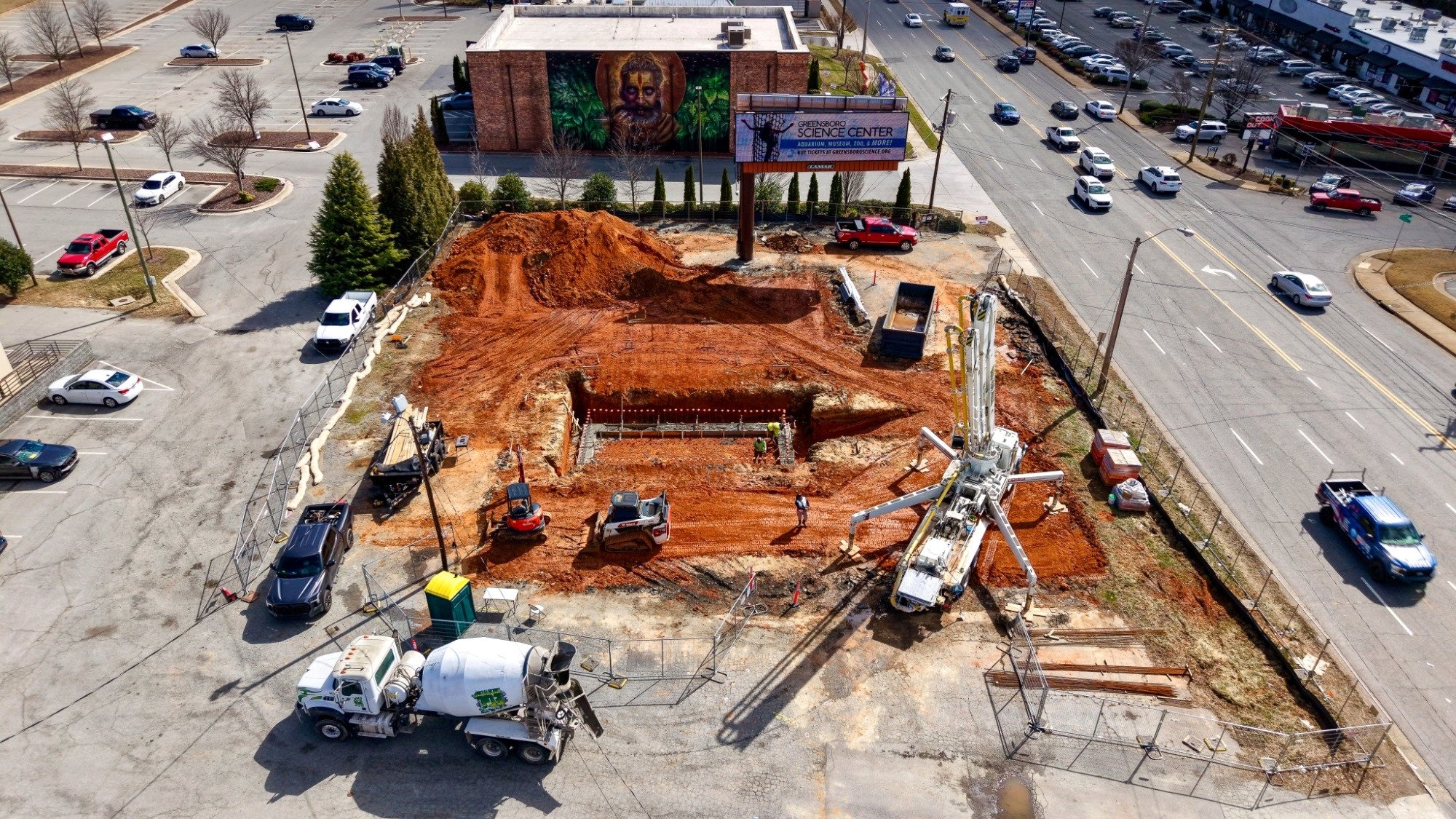 7 Brew Greensboro foundation excavation, late March 2026